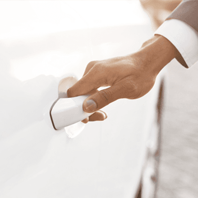Closeup view business man hand on car door