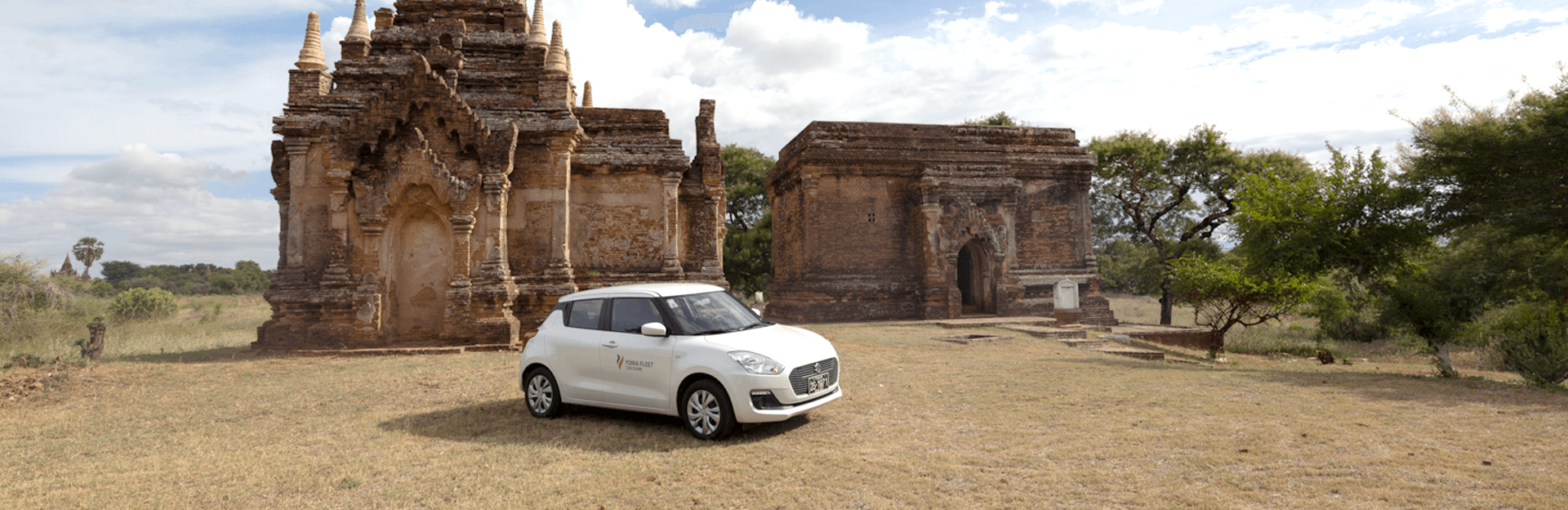 Business man hand on apple watch and steering wheel of a car that is blinded by bright sunlight in the windshield