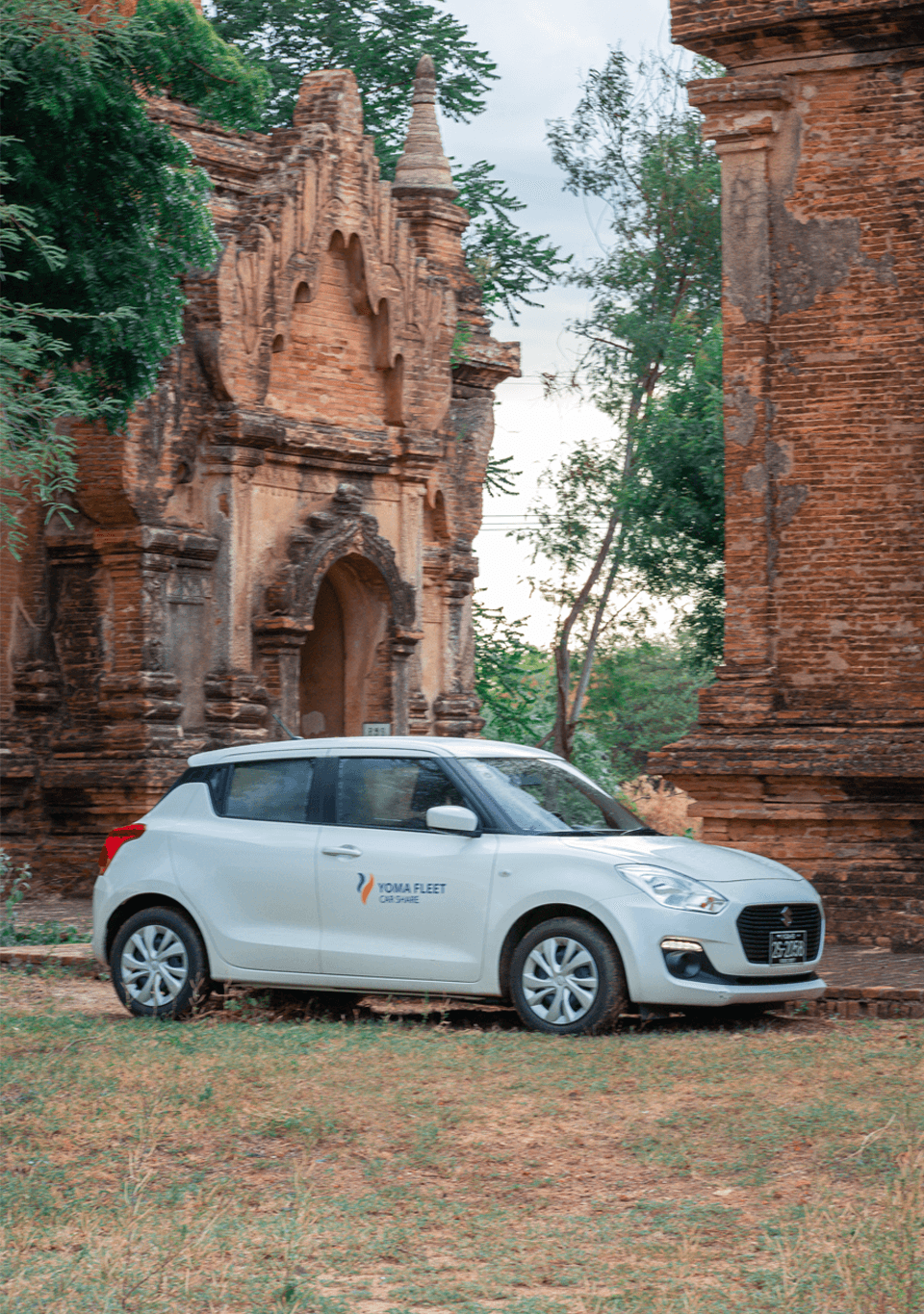 Joining Member Myanmar man with luggage and a phone in his hand near the rental car in rental parking business trip